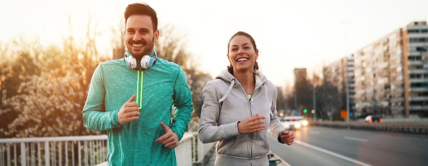 a man and woman posing for a picture on a bridge