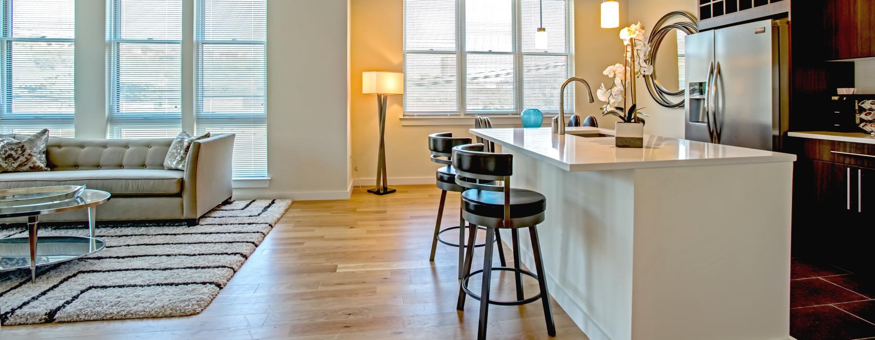 a kitchen with a bar stool and a couch