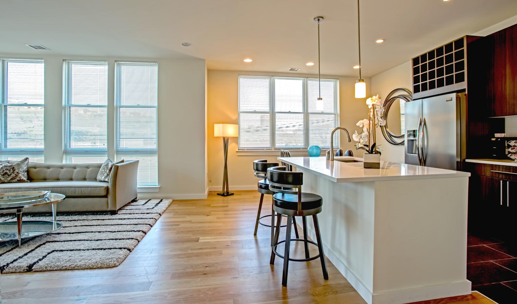 a kitchen with a bar stool and a couch