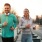 a man and woman posing for a picture on a bridge
